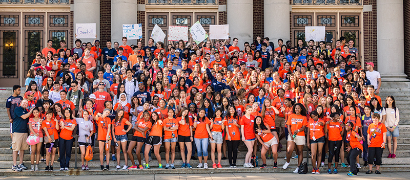 Large group of Service First student volunteers on stairs in front of Foellinger Auditorium