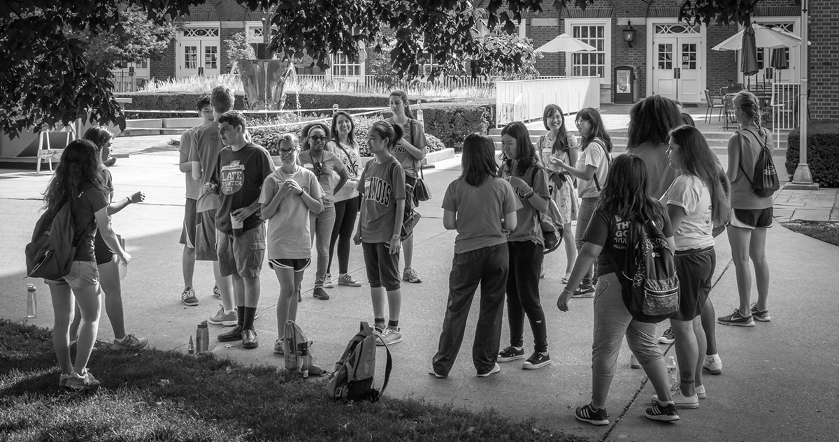 Black and white photo of a group of student volunteers helping in front of the Illini Union.